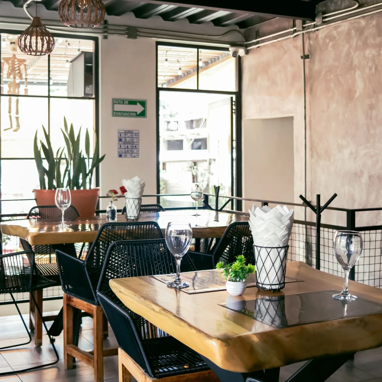 A modern restaurant dining room with soft natural light.