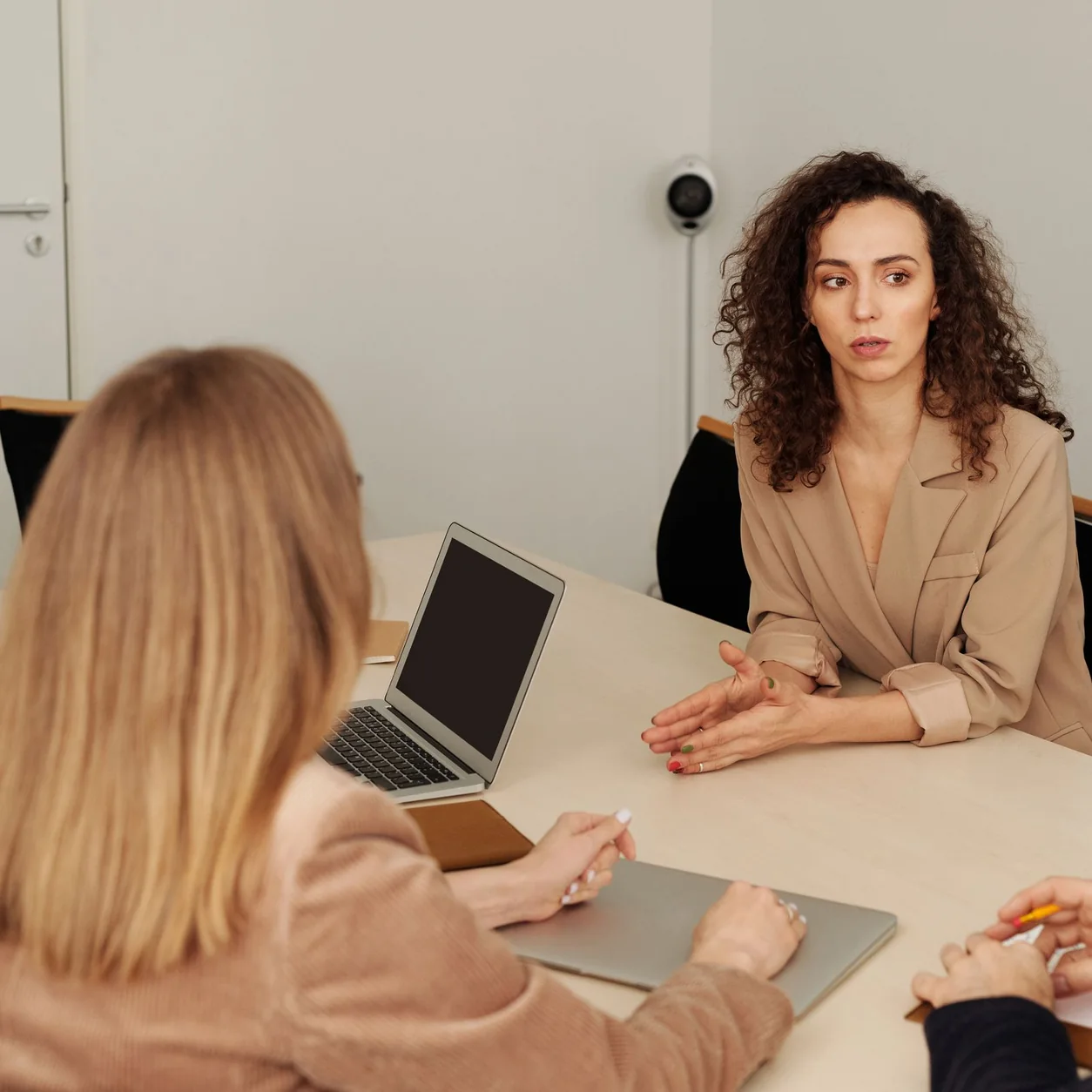 Colleagues collaborating around a table in a bright office.