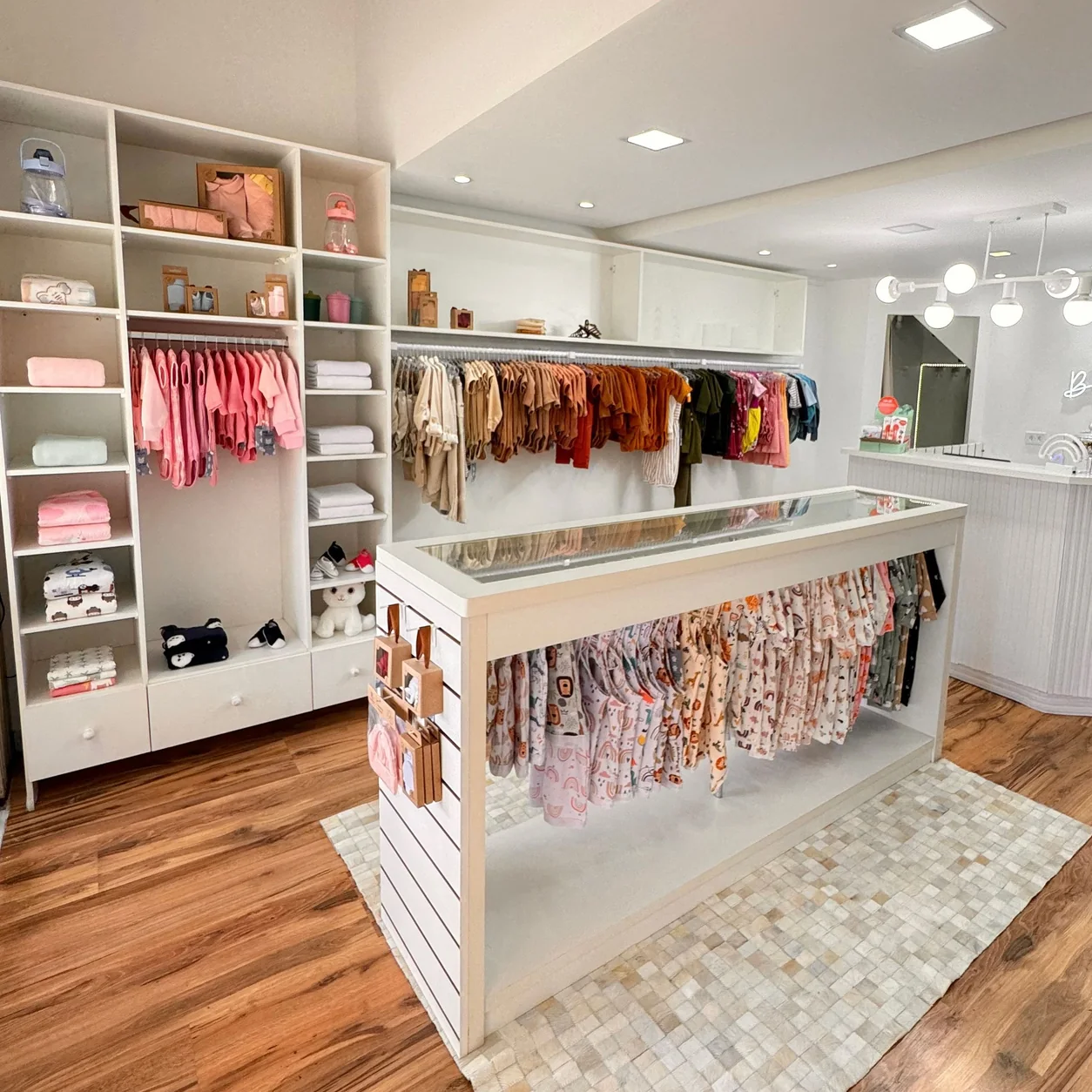 A bright children's clothing boutique with pastel garments.