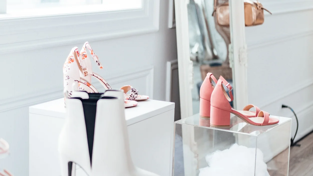 Modern shoe collection elegantly displayed in a chic boutique with natural lighting.