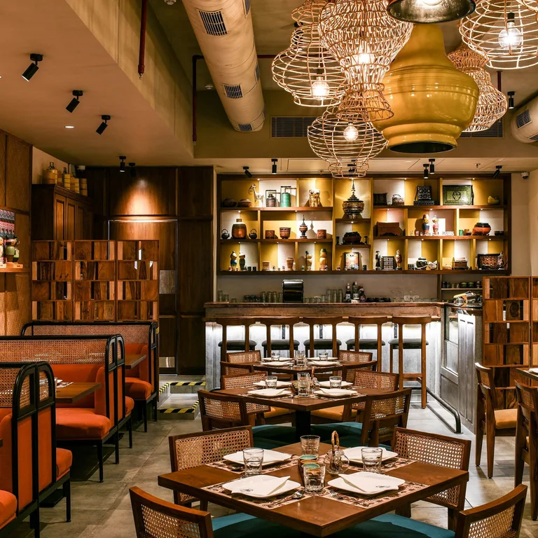Cozy restaurant interior with ambient lighting and elegant table setting for an inviting dining experience.