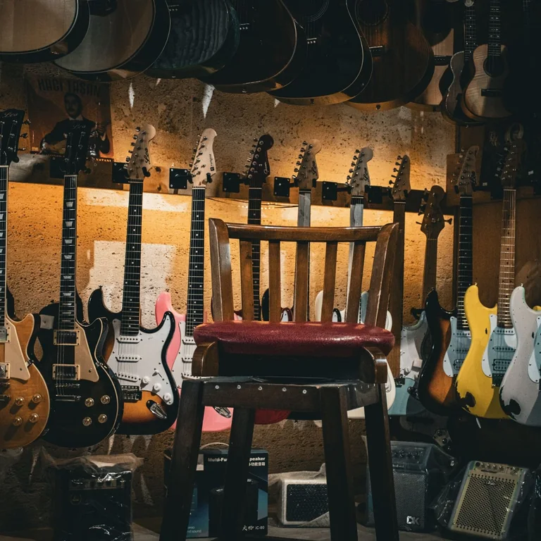 Acoustic and electric guitars line the walls of a music shop.