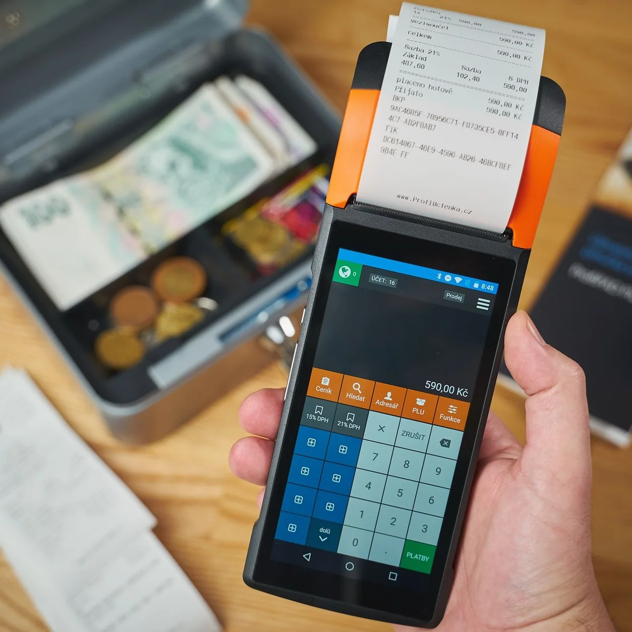 A handheld terminal prints a paper receipt.