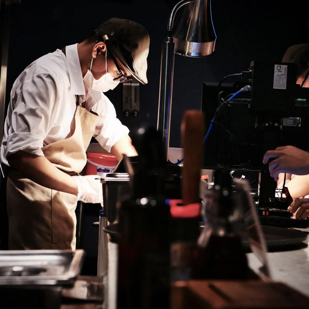 Chefs in a busy restaurant kitchen preparing dishes with precision and teamwork.