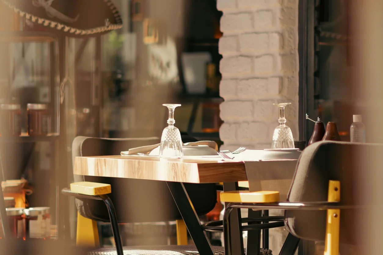 Warm and inviting restaurant interior with an elegantly set table and soft lighting.