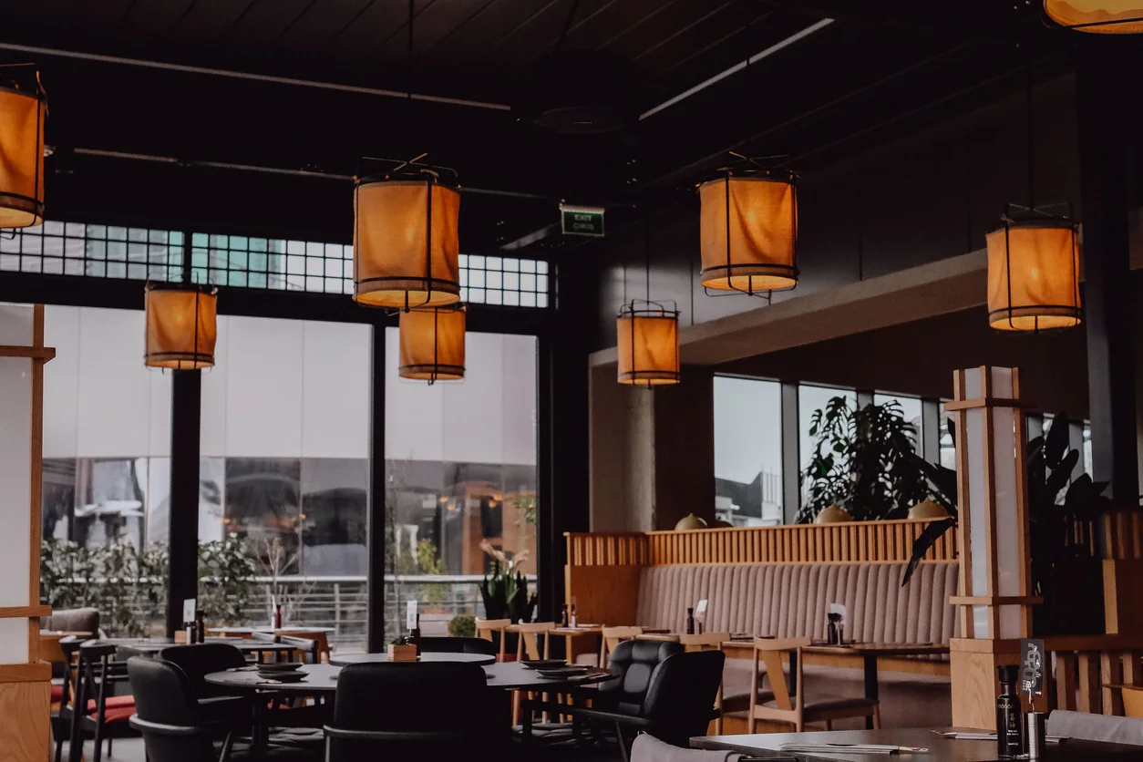 A modern restaurant interior featuring warm lighting and a cozy atmosphere.