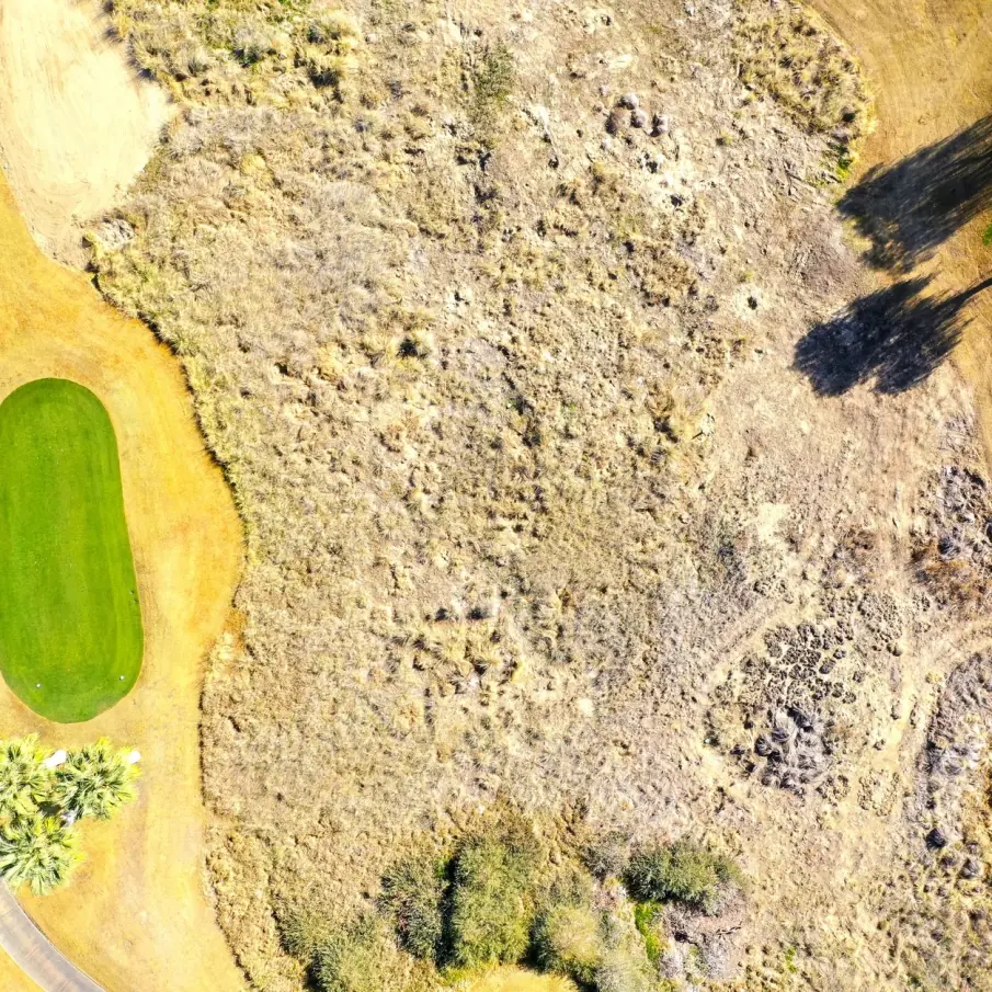 Stunning aerial shot of a golf course landscape in La Quinta, California, highlighting greens and natural textures.