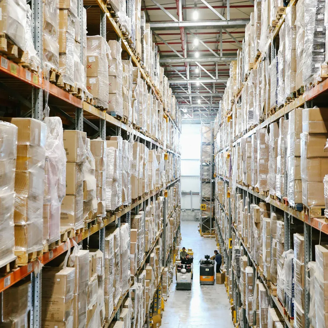 Organized warehouse aisles with boxed merchandise.