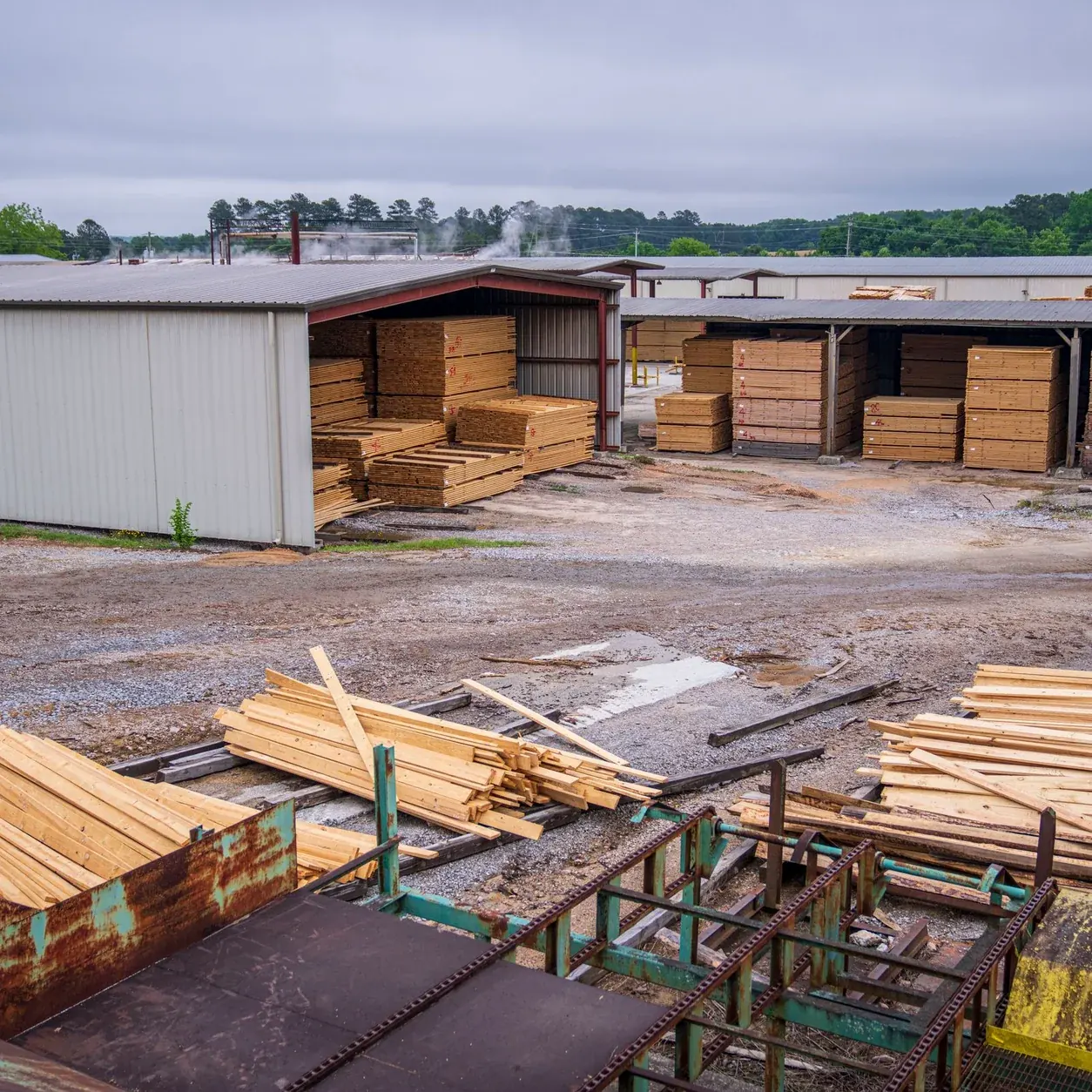 Neatly stacked lumber inside a timber warehouse.